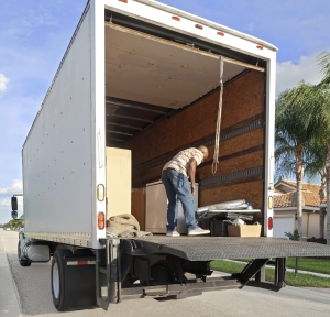 Delivery driver unloading a straight truck using liftgate